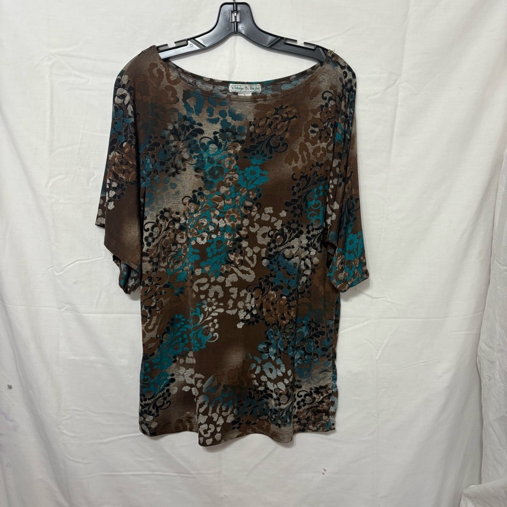 Three-quarter sleeve top with a brown, blue, and white abstract or print.
